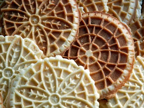 A neat stack of patterned pizzelle wafer cookies