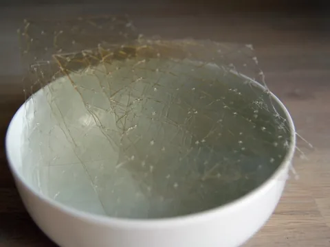 Transparent culinary gelatin sheets in a bowl