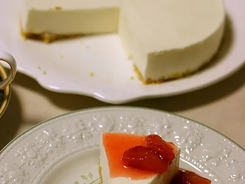 A slice of prepared no-bake cheesecake with strawberry sauce
