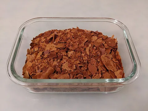 Crushed feuilletine flakes in a clear dish