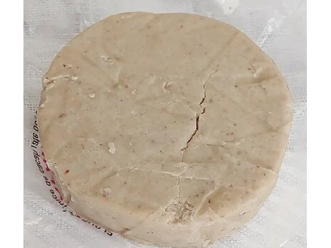 An unwrapped Mexican peanut mazapán disc