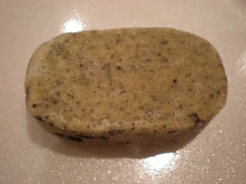 A pressed Filipino polvoron in a cookies and cream variant