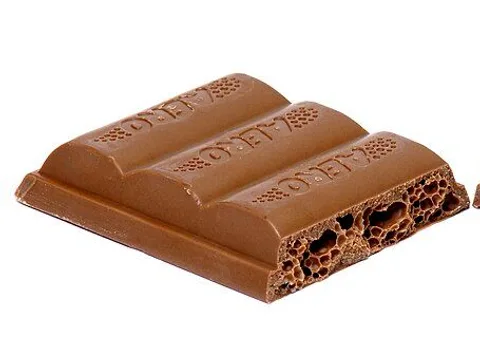 A split Aero milk chocolate bar showing its aerated interior