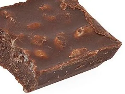 A broken chocolate piece showing crisped grain in the chocolate