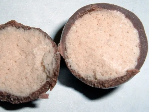 WHOPPERS chocolate-coated malted milk balls with a cut center