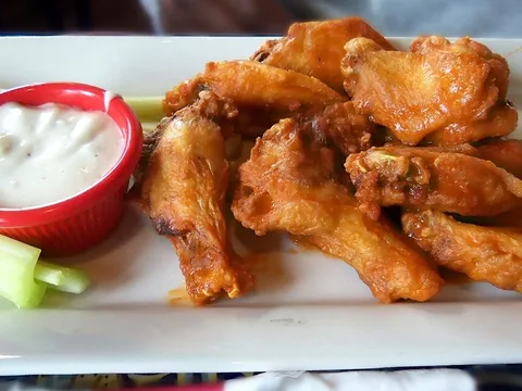 Buffalo sauce coating chicken wings