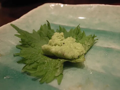 Prepared wasabi paste on green shiso leaves