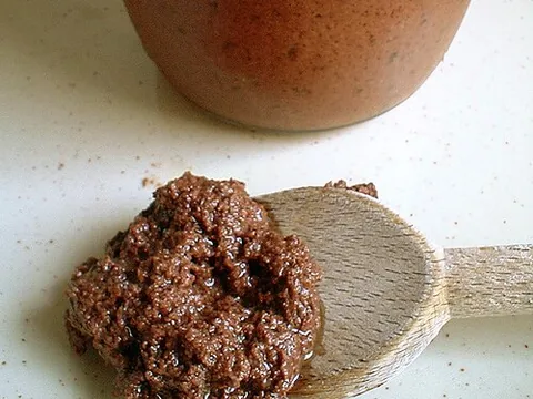 Olive tapenade on a wooden spoon