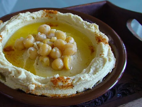 Prepared hummus garnished with chickpeas and olive oil