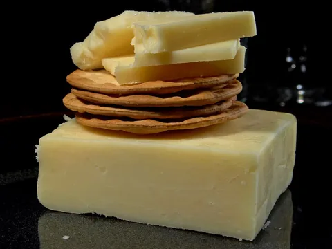 A piece of white cheddar cheese