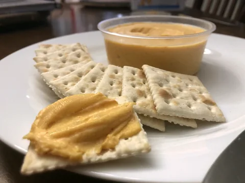 Prepared beer cheese spread with saltine crackers