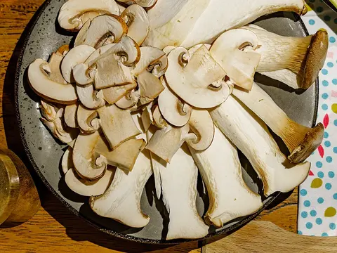 Fresh king trumpet mushrooms sliced on a plate