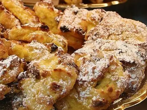 Golden raisin-studded Venetian zaletti biscuits on a tray