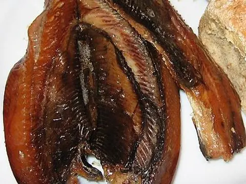 Split smoked herring fillets on a white plate