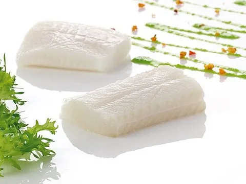 Plated Greenland halibut fillet portions with green sauce