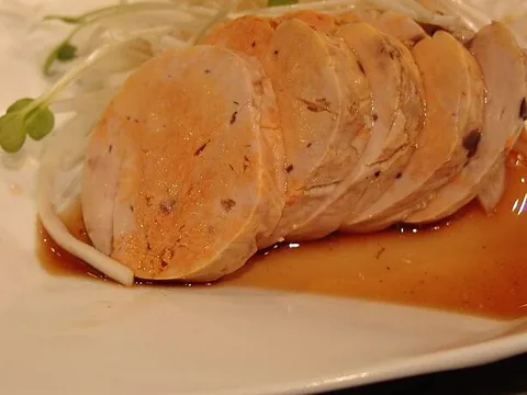 Sliced ankimo monkfish liver on a white plate