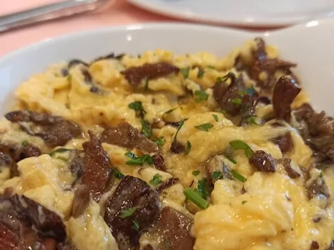 Cooked perretxiko mushrooms in scrambled eggs
