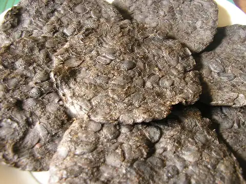 Pressed cakes of fermented iru locust-bean condiment