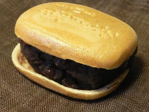 A sweet monaka wafer with red-bean filling exposed