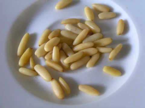Cream-coloured shelled pine nut kernels