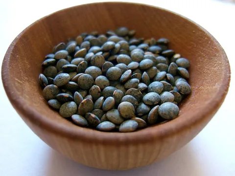Dried French green Puy lentils in a wooden bowl