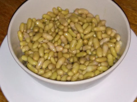 Cooked flageolet beans in a white bowl