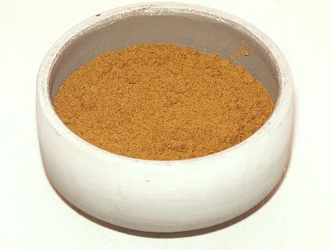 Ras el hanout spice powder in a white bowl