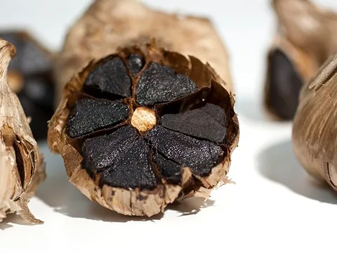 Cut whole black garlic bulb
