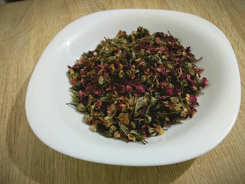 Dried culinary rose buds and petals in a bowl